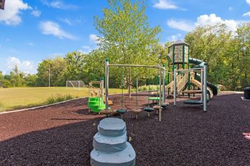 A playground with a slide and other toys in a park
